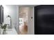 Modern bathroom featuring a black framed mirror, white marble countertop, with an open doorway view of the dining area at 382 Riverside Dr, Ormond Beach, FL 32176