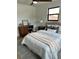 Inviting bedroom showcasing a comfortable bed, side table, and workspace with natural light streaming through the window at 382 Riverside Dr, Ormond Beach, FL 32176