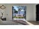 A bedroom with a balcony overlooking a lake, creating a serene and picturesque retreat at 382 Riverside Dr, Ormond Beach, FL 32176