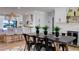 Bright and airy dining area featuring stylish pendant lights, bar stool seating, and access to the kitchen at 382 Riverside Dr, Ormond Beach, FL 32176