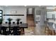 Open-concept dining area with a black table, black chairs, and a patterned rug leads to a staircase at 382 Riverside Dr, Ormond Beach, FL 32176