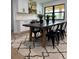 Open dining area features a black table, black chairs, and a patterned rug, complemented by modern white cabinetry at 382 Riverside Dr, Ormond Beach, FL 32176