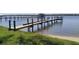 Waterfront dock with railing and a seating area with a beautiful lake view at 382 Riverside Dr, Ormond Beach, FL 32176