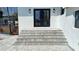 Elegant entrance with stone steps, leading to a covered porch and modern front door at 382 Riverside Dr, Ormond Beach, FL 32176