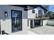 Modern home exterior with a balcony, pool, and sliding doors for indoor-outdoor living at 382 Riverside Dr, Ormond Beach, FL 32176