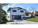 Stunning two-story home featuring modern design, gray garage door, and lush landscaping at 382 Riverside Dr, Ormond Beach, FL 32176