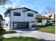 Contemporary two-story home with a two-car garage, modern design, and well-manicured lawn at 382 Riverside Dr, Ormond Beach, FL 32176