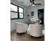 Modern home office with unique lighting, black frame window, and comfortable seating at 382 Riverside Dr, Ormond Beach, FL 32176