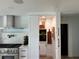 Well-equipped kitchen featuring stainless steel range hood, white cabinets, and open shelving displaying decor at 382 Riverside Dr, Ormond Beach, FL 32176