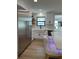 Modern kitchen featuring stainless steel refrigerator, white cabinetry, and a farmhouse sink with beautiful countertops at 382 Riverside Dr, Ormond Beach, FL 32176