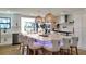 Kitchen with white cabinets, large island with seating, and modern lighting at 382 Riverside Dr, Ormond Beach, FL 32176