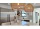 Modern kitchen featuring stainless steel refrigerator, white cabinetry, farmhouse sink, and pendant lighting at 382 Riverside Dr, Ormond Beach, FL 32176