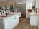 Spacious kitchen featuring stainless steel refrigerator, stylish pendant lighting, and white cabinetry with modern hardware at 382 Riverside Dr, Ormond Beach, FL 32176