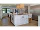 Bright, open kitchen featuring a spacious island, bar stools, pendant lights, and stainless steel refrigerator at 382 Riverside Dr, Ormond Beach, FL 32176