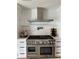 Modern kitchen with a stainless steel range and custom exhaust hood at 382 Riverside Dr, Ormond Beach, FL 32176