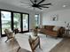 This living room features an oversized ceiling fan, neutral furniture, and scenic waterfront views at 382 Riverside Dr, Ormond Beach, FL 32176