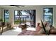 The living room boasts waterfront views through large windows, accented by neutral furniture and stylish accents at 382 Riverside Dr, Ormond Beach, FL 32176