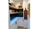 Organized pantry with floating shelves, white cabinets, and marble countertops with decor at 382 Riverside Dr, Ormond Beach, FL 32176