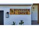Close-up of the address sign on white brick with a modern exterior light at 382 Riverside Dr, Ormond Beach, FL 32176