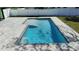 Rectangular pool with light blue water, surrounded by a paver patio and green grass at 382 Riverside Dr, Ormond Beach, FL 32176