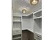 Well-lit walk-in closet with ample shelving and drawer space for storage at 382 Riverside Dr, Ormond Beach, FL 32176