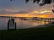 Expansive waterfront view from this home, featuring a private dock with multiple slips and stunning sunset at 382 Riverside Dr, Ormond Beach, FL 32176