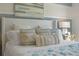 Comfortable bedroom featuring a plush bed with decorative pillows, a stylish headboard, and a bedside table with a lamp at 3917 Diving Dove Ln, Bartow, FL 33830
