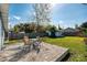 Large backyard featuring a brick patio with furniture, grass, and a storage shed at 430 E Crystal Lake St, Orlando, FL 32806
