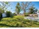 Spacious backyard features a brick patio with furniture, grass, a storage shed, and a fence at 430 E Crystal Lake St, Orlando, FL 32806