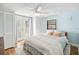Cozy bedroom with a ceiling fan, french doors, plush bedding, and two closets at 430 E Crystal Lake St, Orlando, FL 32806