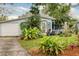 Charming house exterior with manicured front yard and driveway leading to the garage at 430 E Crystal Lake St, Orlando, FL 32806