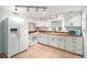Bright kitchen features white cabinetry, wood countertops, tile floors, and modern appliances at 430 E Crystal Lake St, Orlando, FL 32806