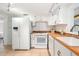 Bright kitchen with white cabinets, white appliances, and laminate countertop at 430 E Crystal Lake St, Orlando, FL 32806