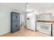 Bright kitchen featuring white appliances, pantry cabinet, and tile floors at 430 E Crystal Lake St, Orlando, FL 32806