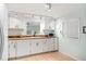 Bright kitchen features white cabinetry, wood countertops, tile floors, and modern track lighting at 430 E Crystal Lake St, Orlando, FL 32806