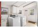 A laundry room featuring a washer, a dryer, and cabinets for storage at 430 E Crystal Lake St, Orlando, FL 32806