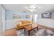 Living room features hardwood floors, comfortable seating, and bright, natural light at 430 E Crystal Lake St, Orlando, FL 32806