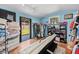 Sunlit room with a sofa, storage, and clothing racks, leading to the backyard at 430 E Crystal Lake St, Orlando, FL 32806