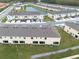 Aerial view showcasing the community of multi-Gathering homes, a pond and parking areas at 4715 Coral Castle Dr, Kissimmee, FL 34746