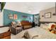 Cozy bedroom with a crib, recliner, and a full-sized bed, designed for both comfort and functionality at 4715 Coral Castle Dr, Kissimmee, FL 34746