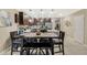 Open dining room with a large table, stylish chairs, and views into the modern kitchen, perfect for Gathering gatherings at 4715 Coral Castle Dr, Kissimmee, FL 34746