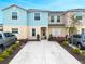 Attractive townhome featuring a well-maintained yard and a double-wide driveway with ample parking space at 4715 Coral Castle Dr, Kissimmee, FL 34746