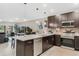 Modern kitchen featuring stainless steel appliances, granite countertops, and dark cabinetry at 4715 Coral Castle Dr, Kissimmee, FL 34746