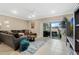 Inviting living room with tile flooring, neutral tones, comfortable seating, and sliding doors to the outdoor space at 4715 Coral Castle Dr, Kissimmee, FL 34746
