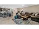 Open-concept living area featuring tile floors, a comfortable sectional sofa, and a dining area at 4715 Coral Castle Dr, Kissimmee, FL 34746