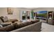 Cozy living room featuring comfortable sofas, tile flooring, and sliding doors leading to an outdoor patio at 4715 Coral Castle Dr, Kissimmee, FL 34746