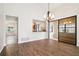 Bright dining room featuring wood floors, chandelier, and pass-through to the kitchen at 545 Ne 45Th Ct, Ocala, FL 34470