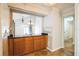 Kitchen with granite countertop, wooden cabinets, and bar seating area open to the living room at 545 Ne 45Th Ct, Ocala, FL 34470