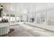 This sunroom has concrete floors and many windows at 545 Ne 45Th Ct, Ocala, FL 34470