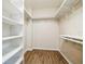 Walk-in closet featuring built in shelves and laminate floors at 545 Ne 45Th Ct, Ocala, FL 34470